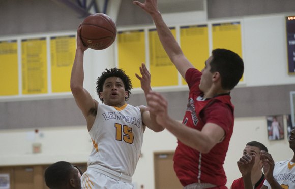 Sean Patrick attempts a basket in Wedensday's loss to Hanford in the Lemoore High School Event Center.